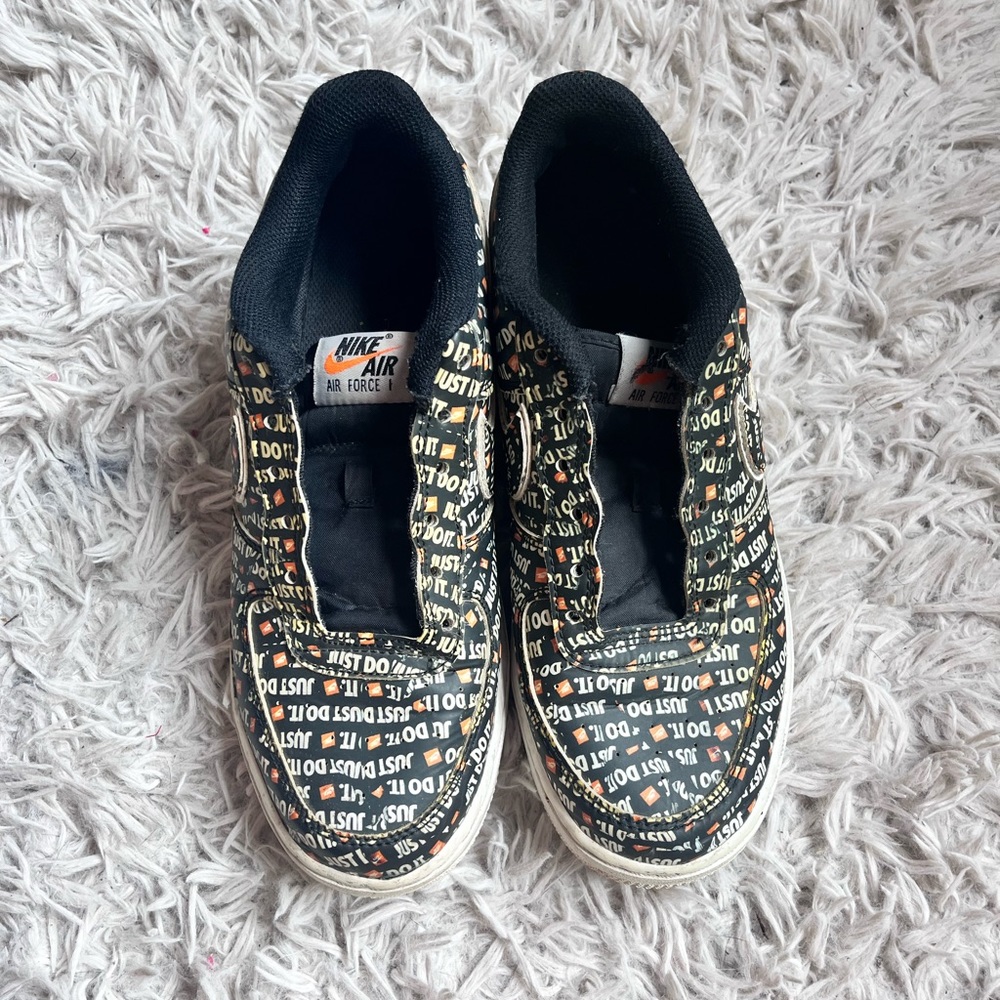Black Nike Air Force 1’s with JustDoit print with creasing